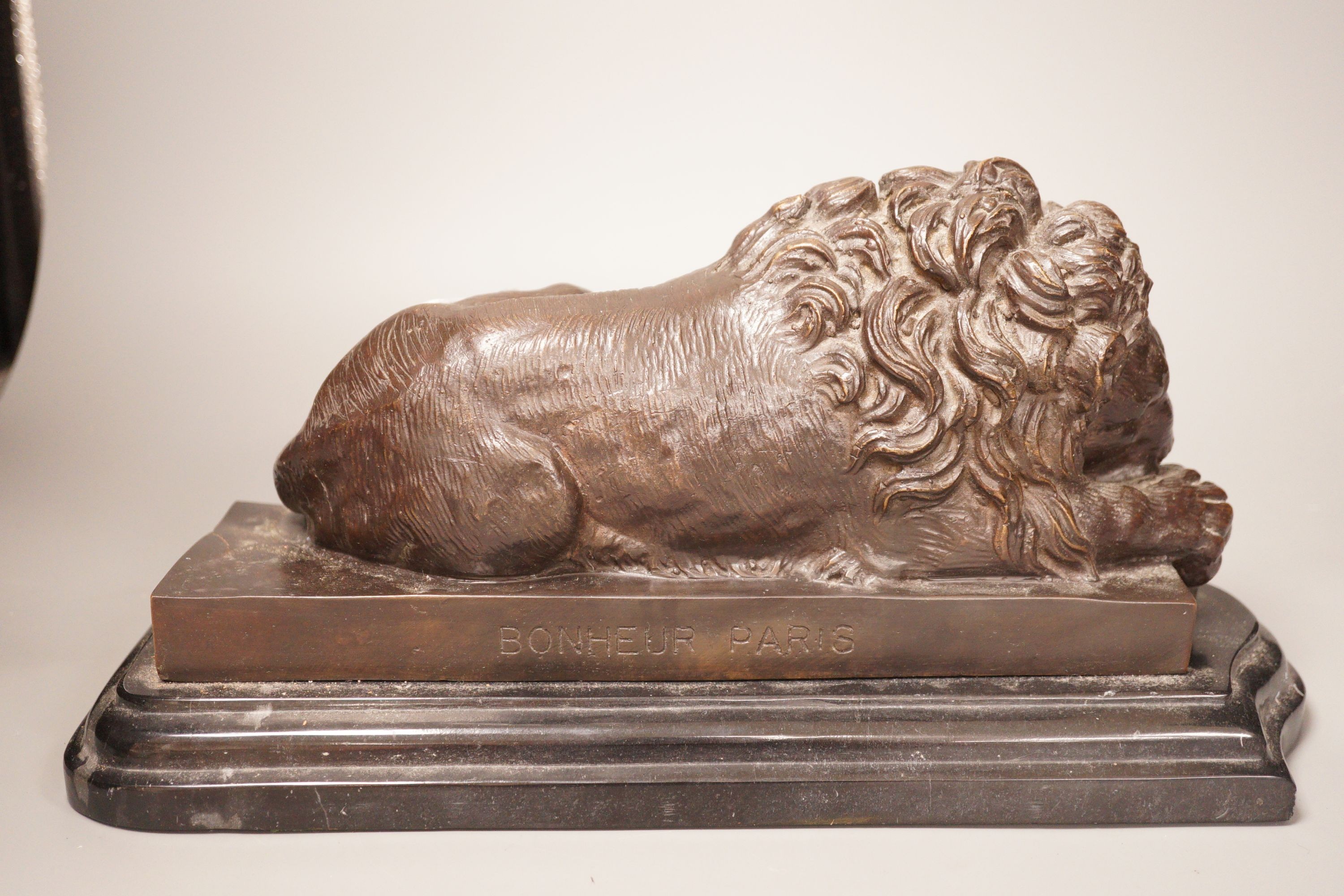 After Isadore Bonheur a bronze figure of a recumbent lion, on marble base, 20th century, 35cm